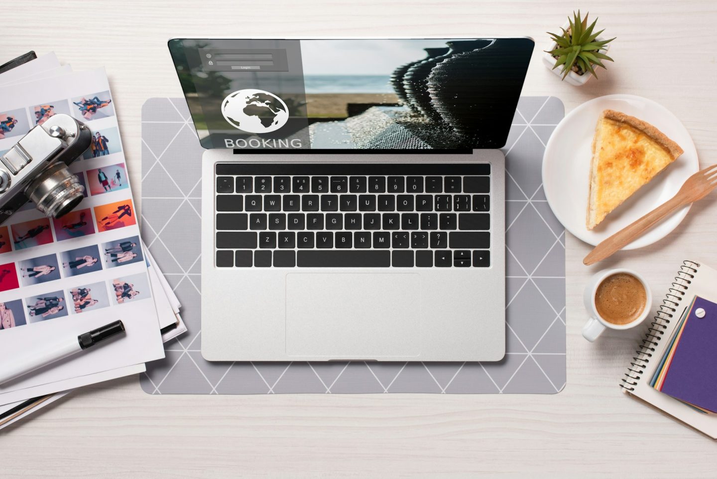 office desk with laptop with booking website on screen, flat lay
