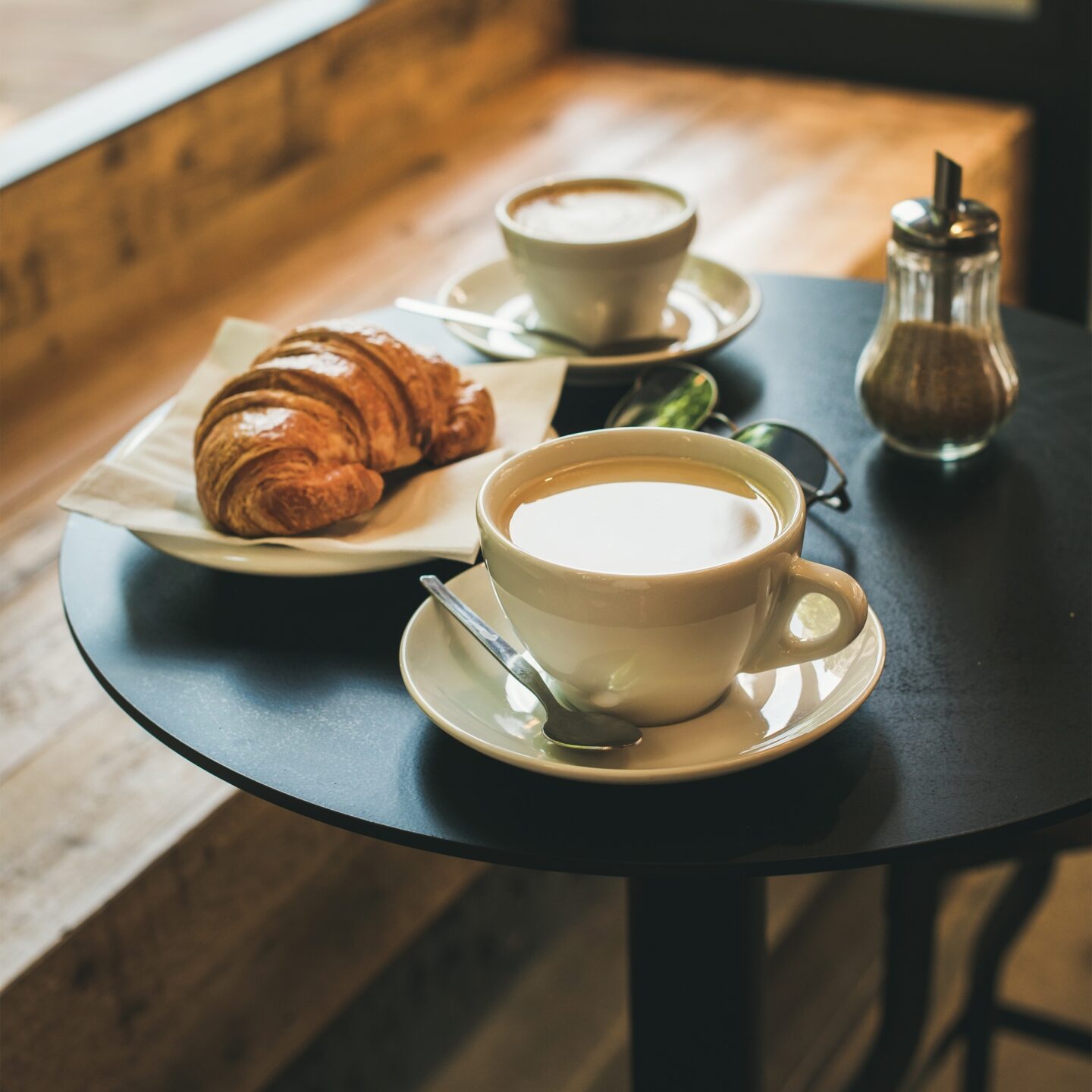 Coffee latte, cappuccino and croissant on table , square crop
