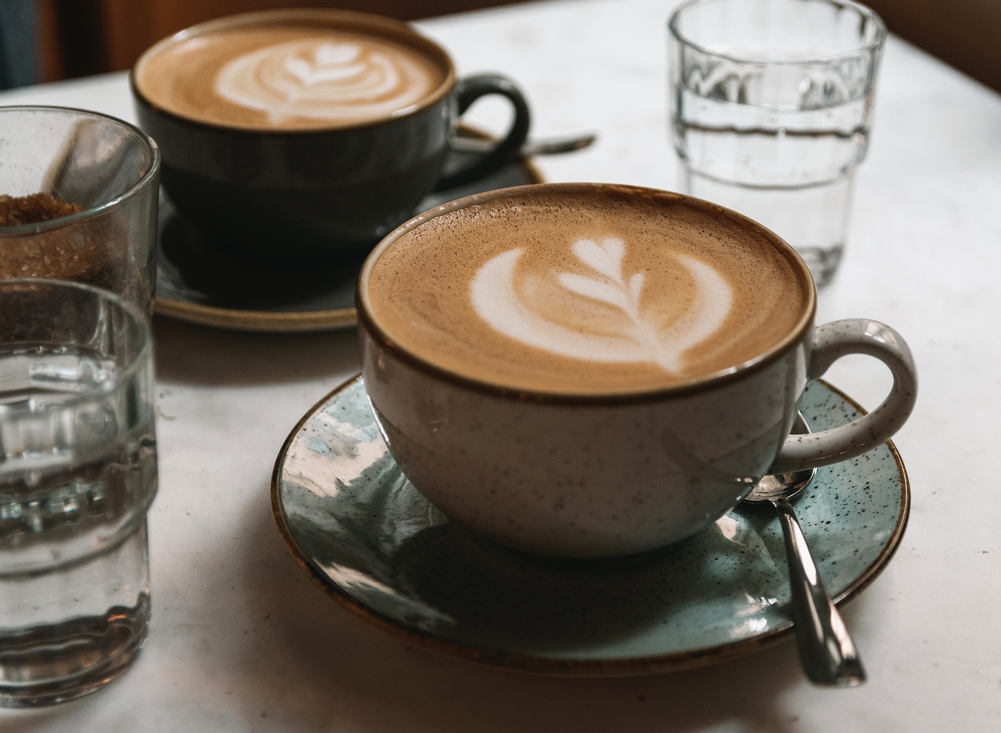 Cup of coffee with latte art on table in cafe