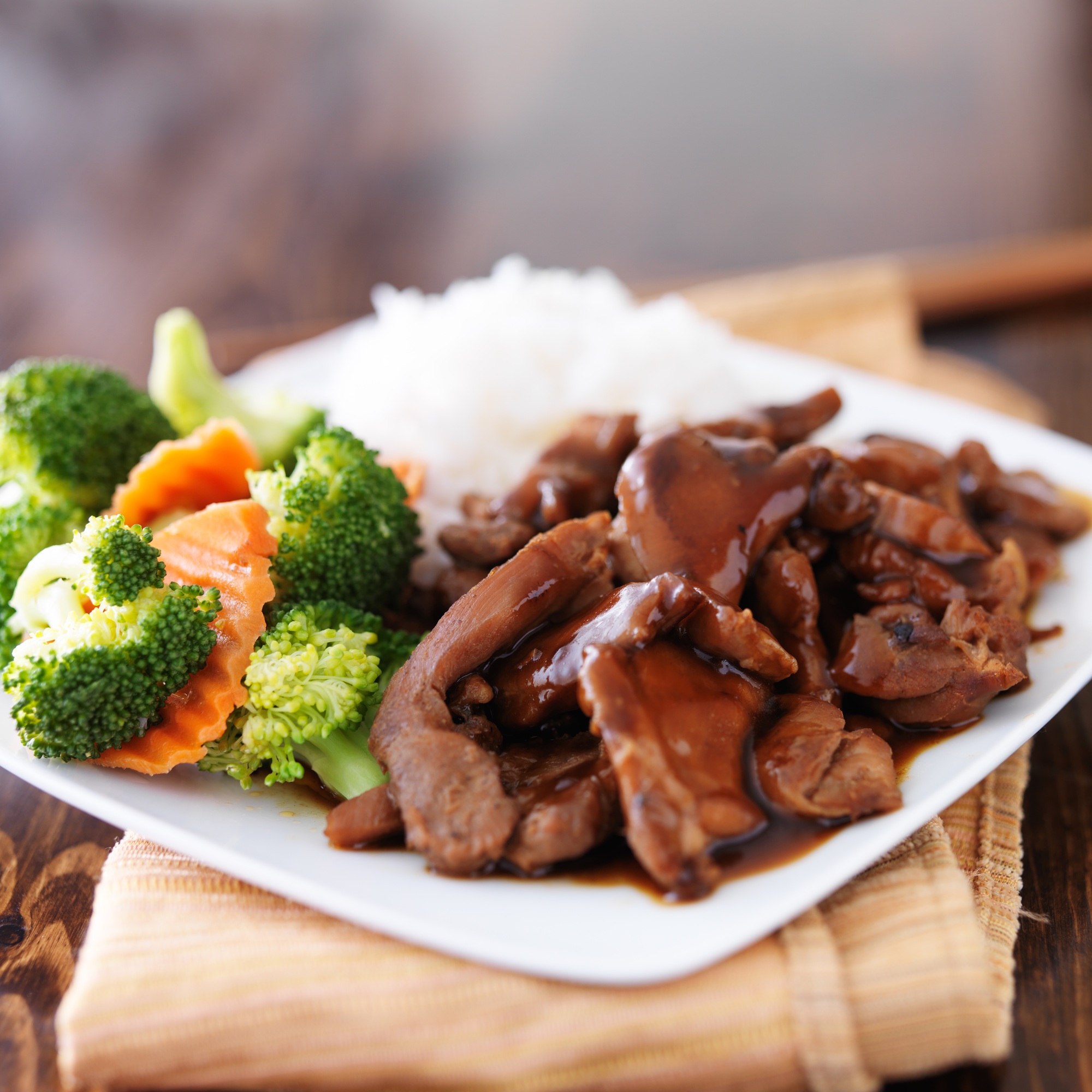 japanese chicken teriyaki with rice and vegetables on wood table