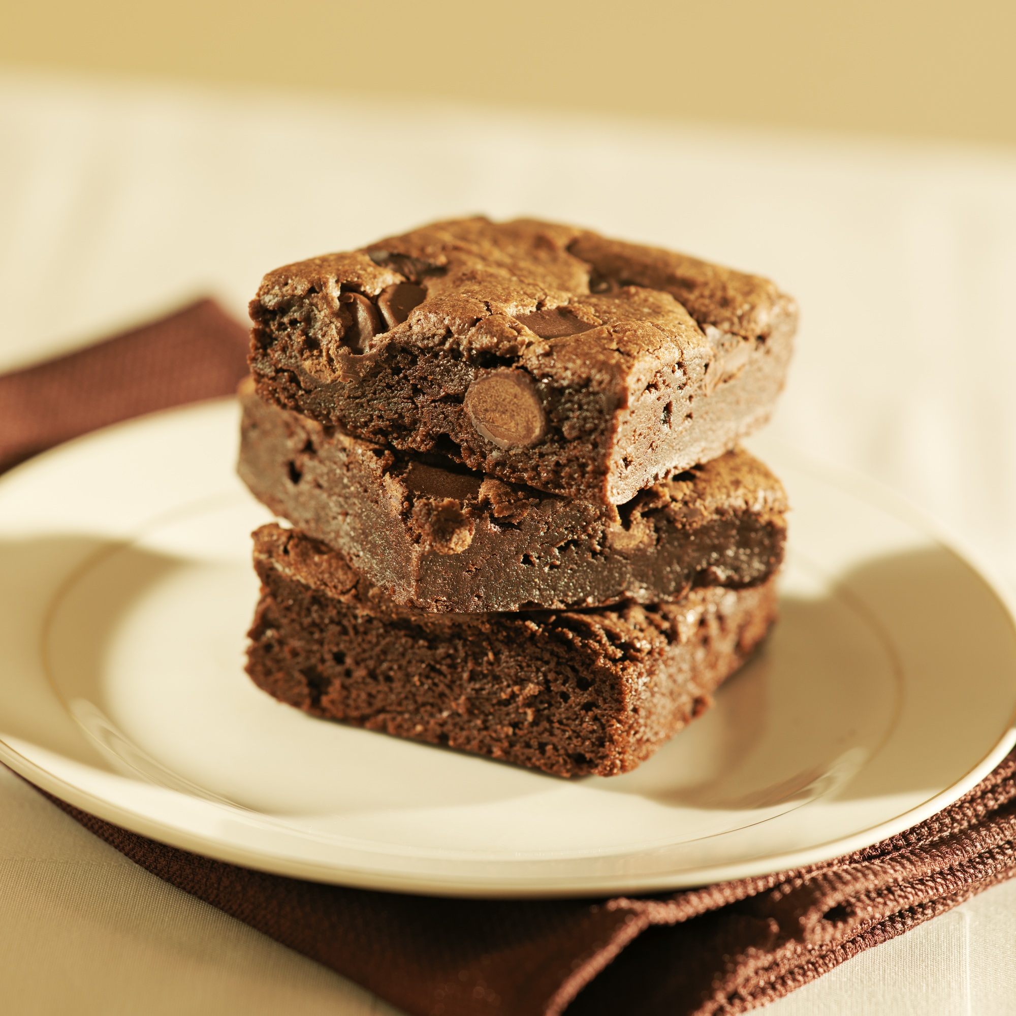 Stack of brownies on a plate.