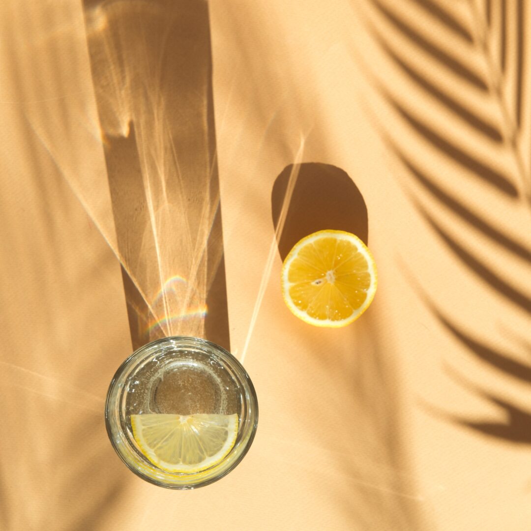 summer background with lemonade and palm tree shadow