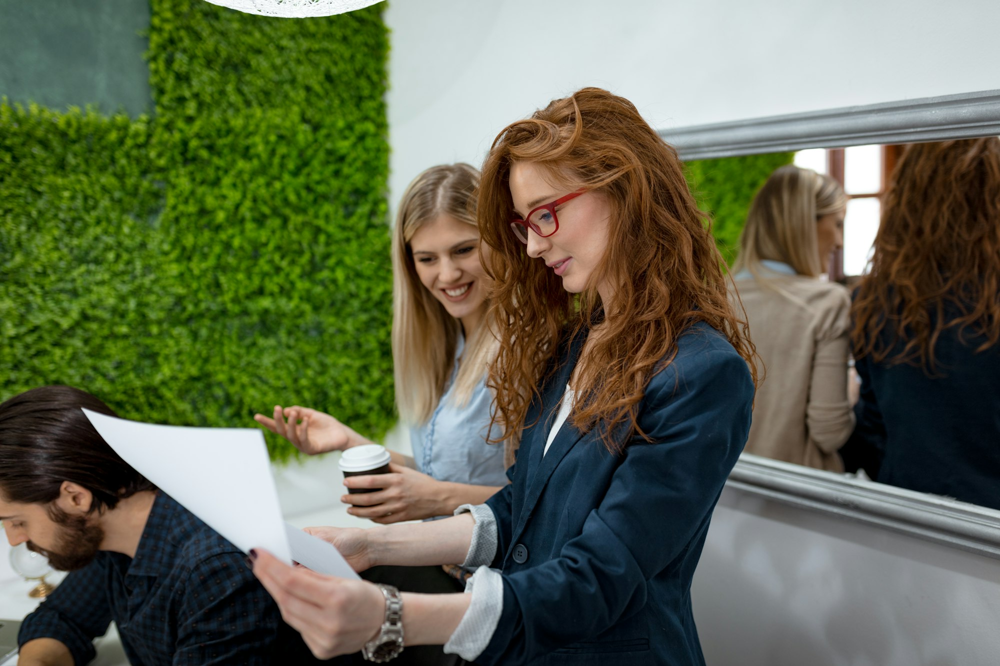 Businesswomen Consulting A Report Together