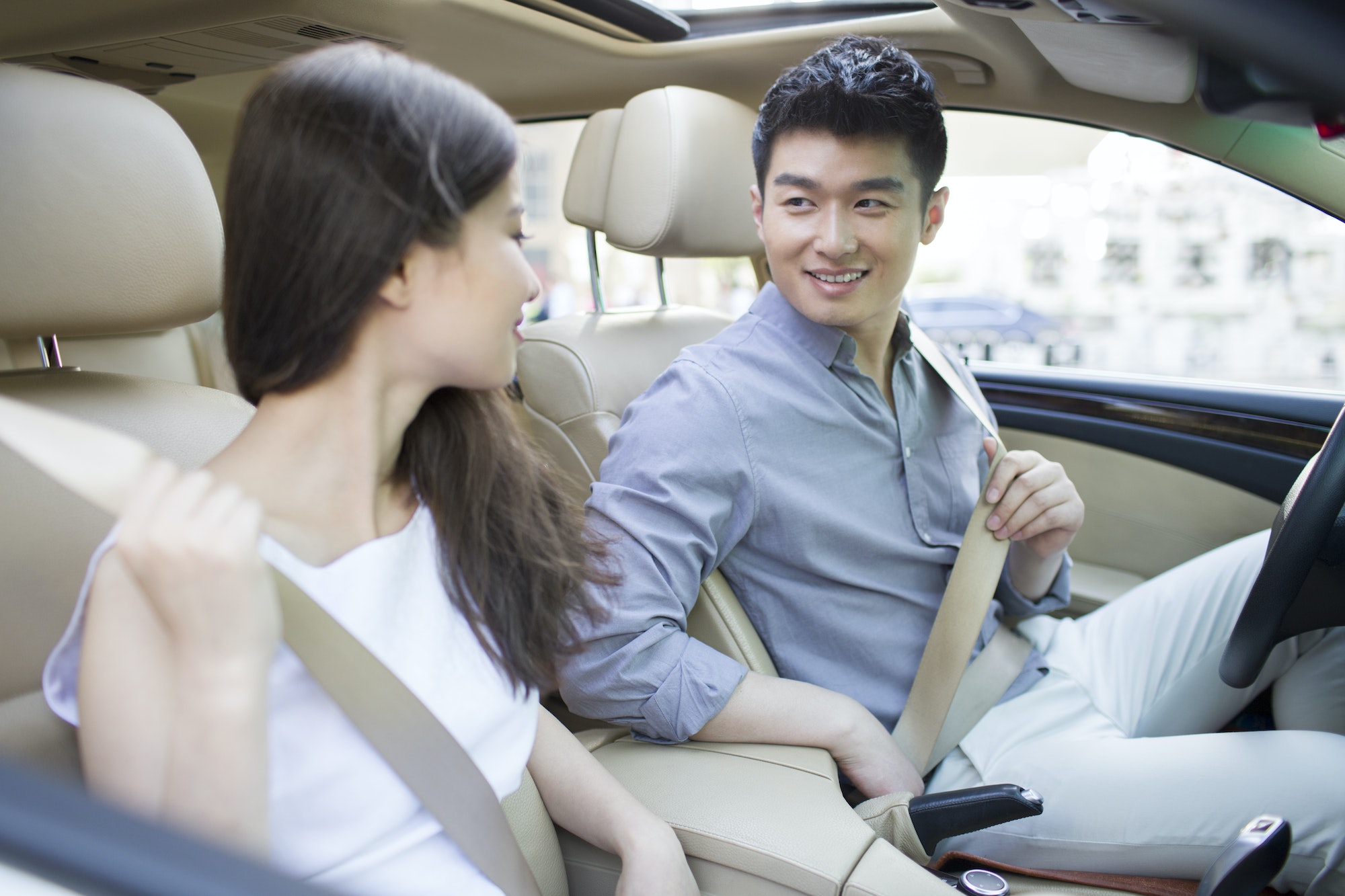 Happy young couple in a car