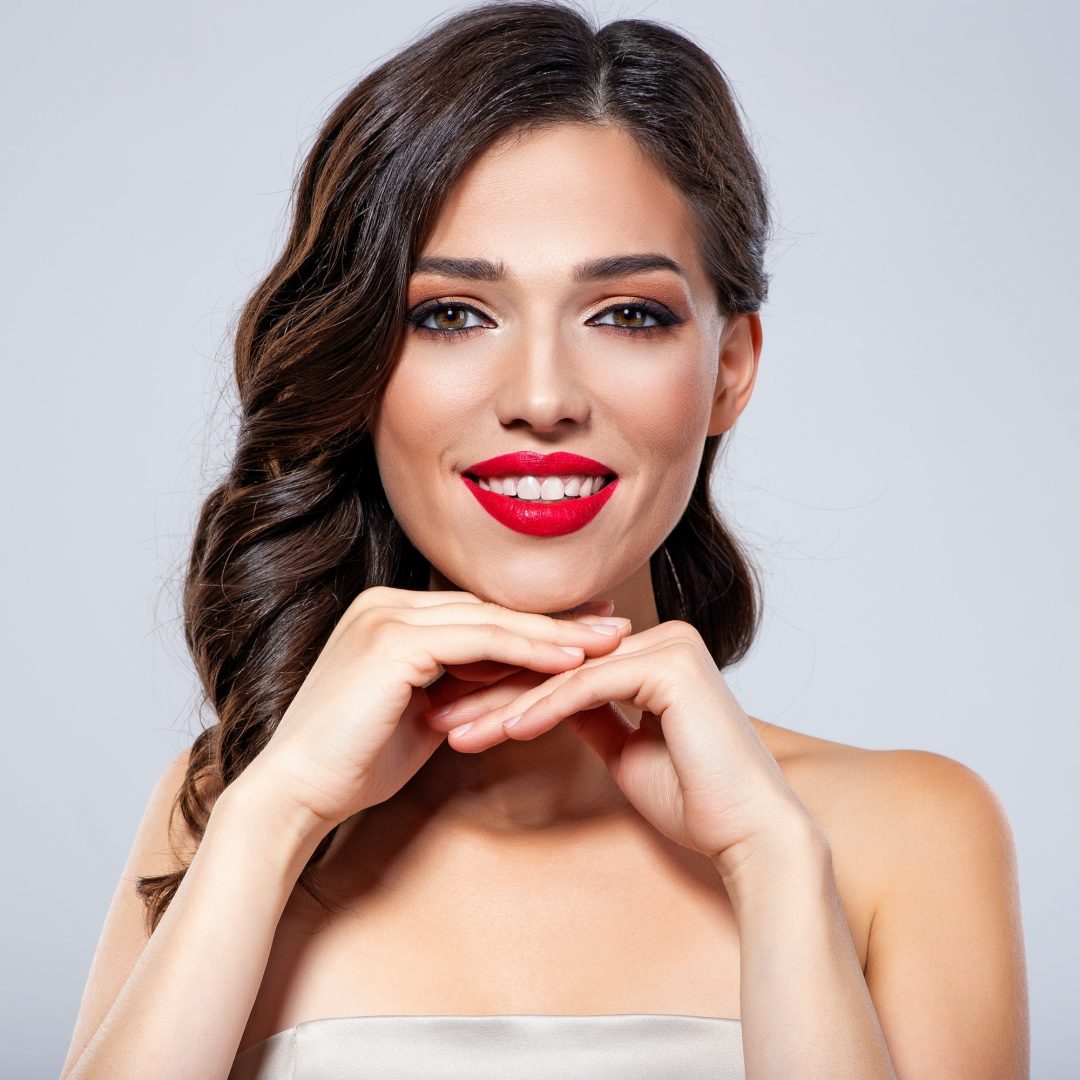 Young smiling woman with brown hair.