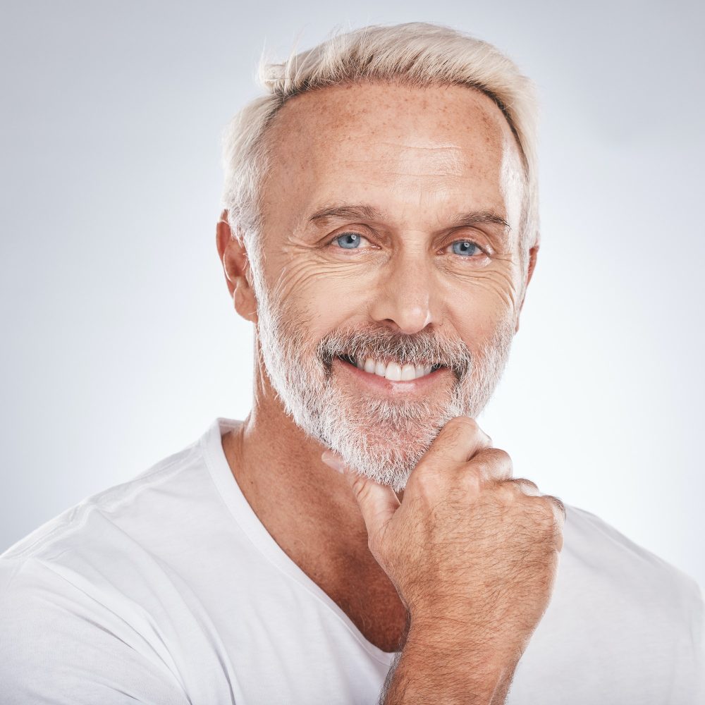 Face portrait, thinking and senior man in studio isolated on a gray background. Skincare, cosmetics