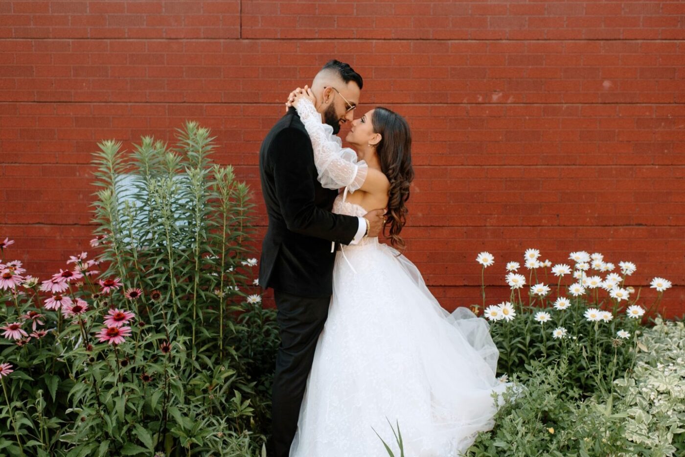 Wedding bliss against a brick wall backdrop