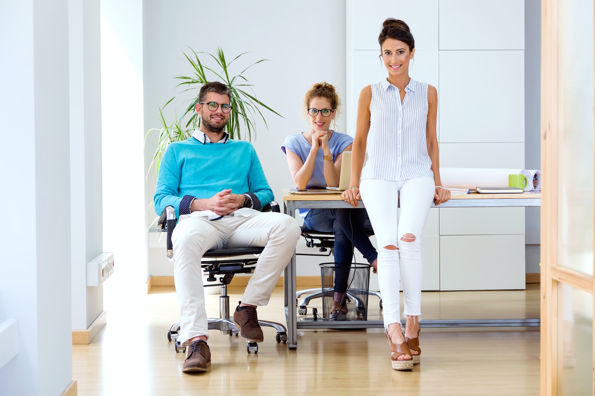 Group of business people looking at camera in modern office.