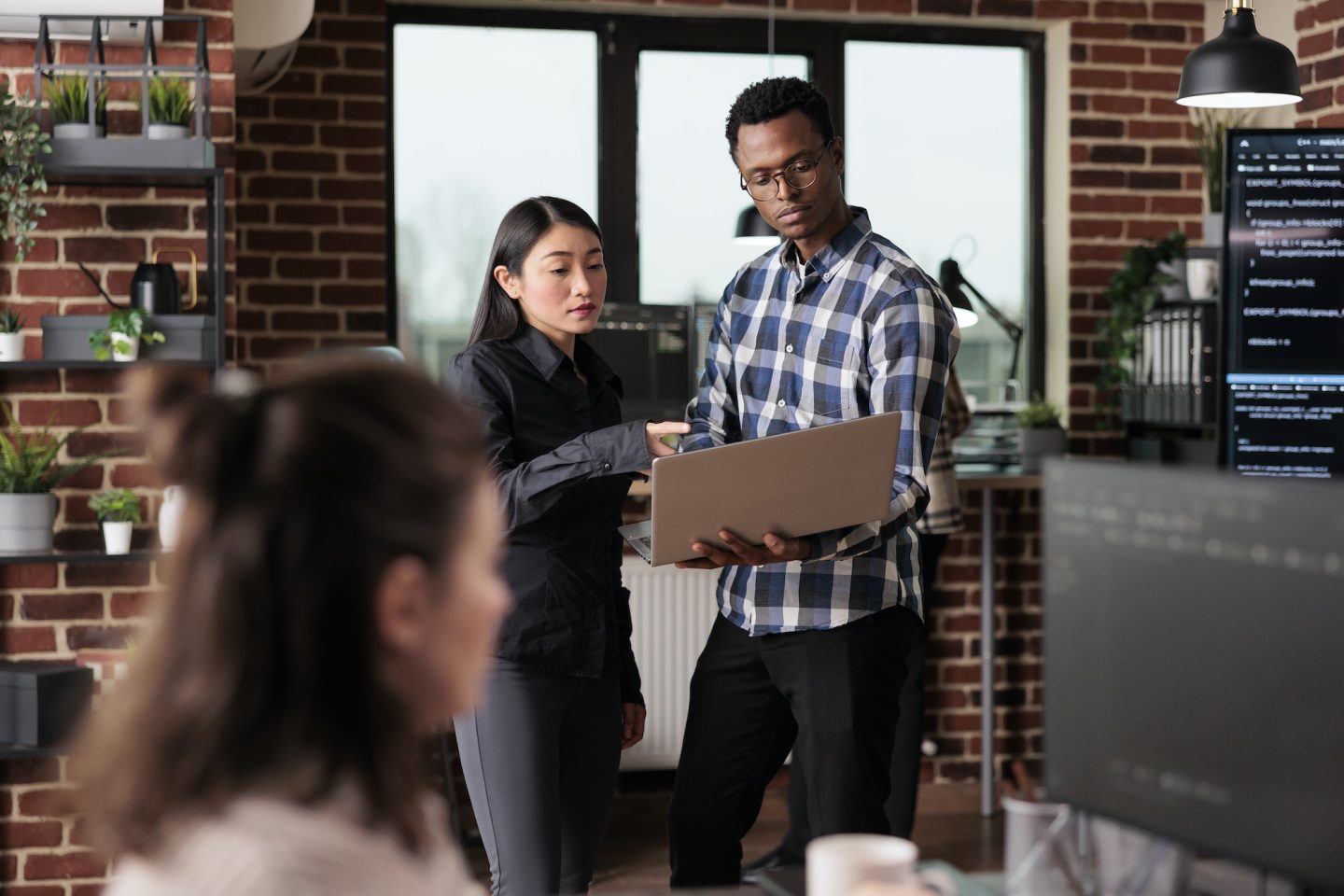 Cyber security agency employees using laptop to monitoring internet bandwidth and database used