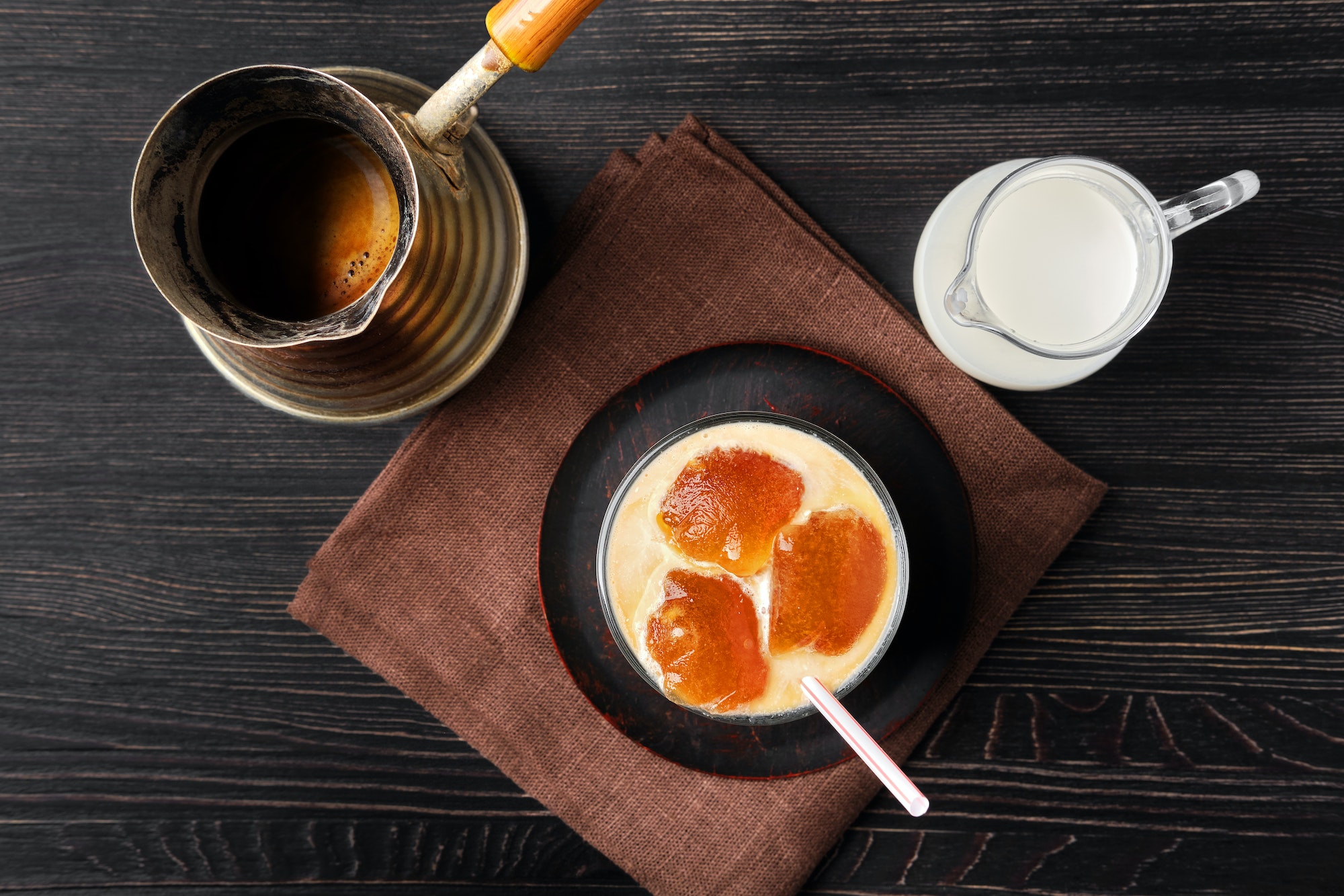 Top view of iced latte with frozen coffee cubes and cream