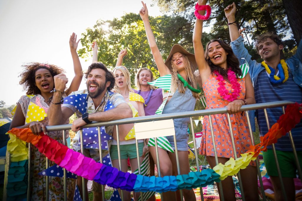 Group of friends dancing at music festival