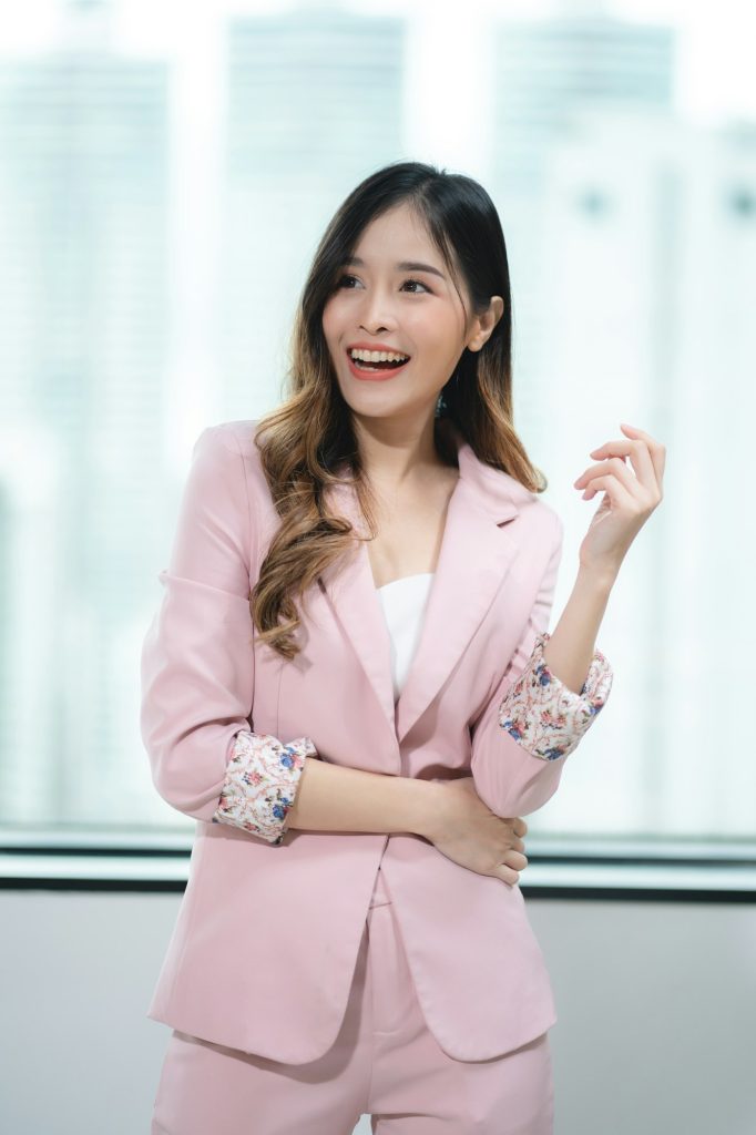 Happy confident smiling young professional Asian business woman corporate leader