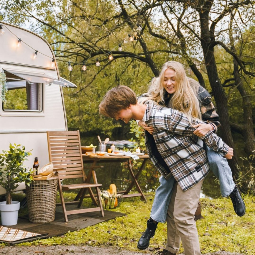 Young just married couple traveling in camper,house on wheels,trailer,motor home.Love romantic road
