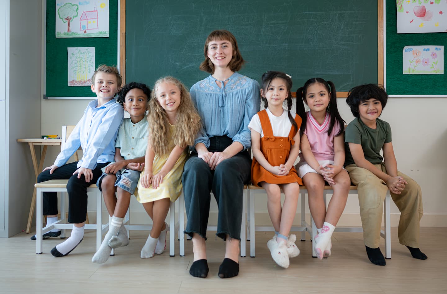portrait-of-a-teacher-and-kids-in-a-classroom-wher-K2B6GQ9