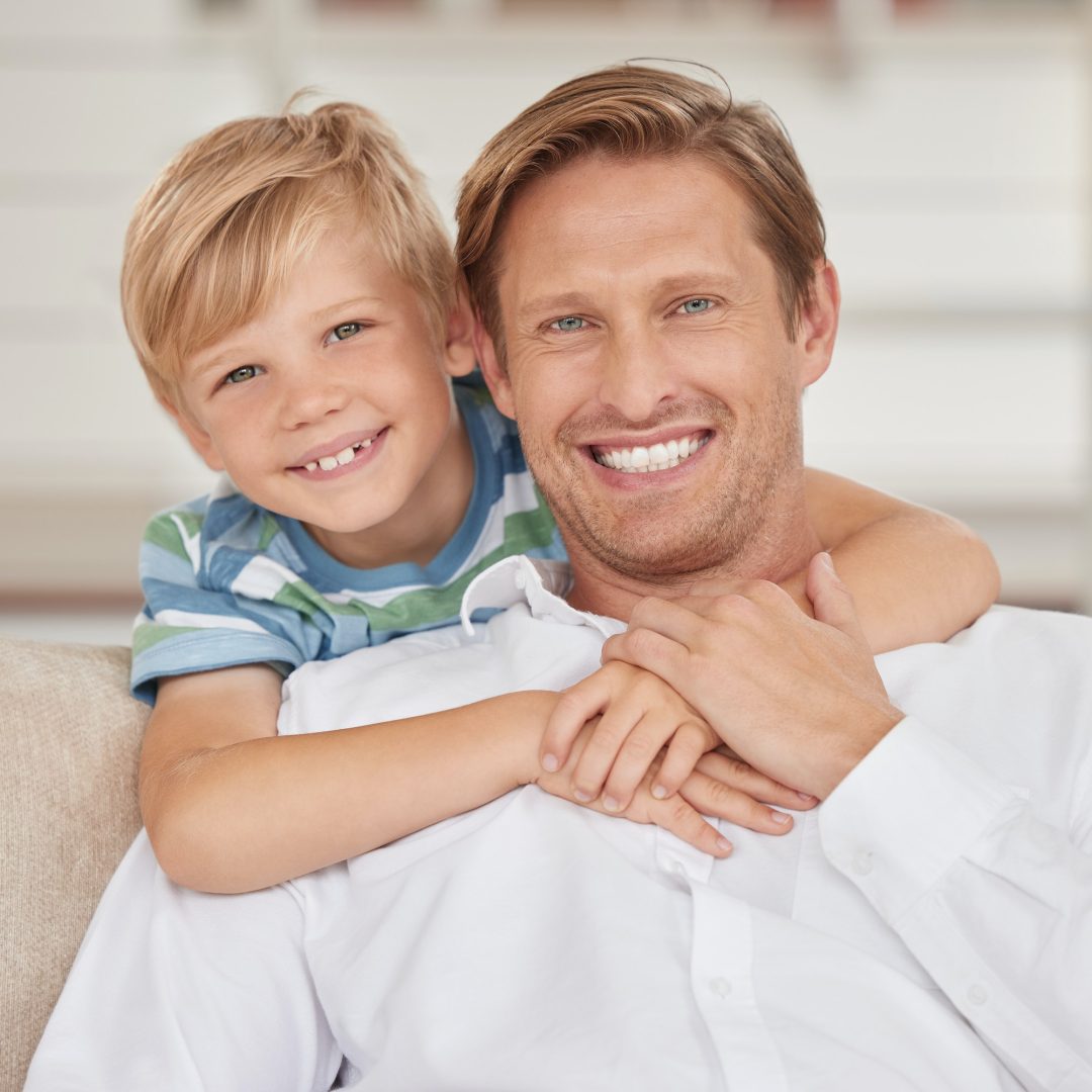 Family, love and portrait of father with son sitting on the sofa, smile of faces. Happiness, affect