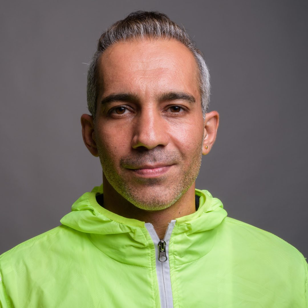 Handsome Persian man with gray hair wearing jacket