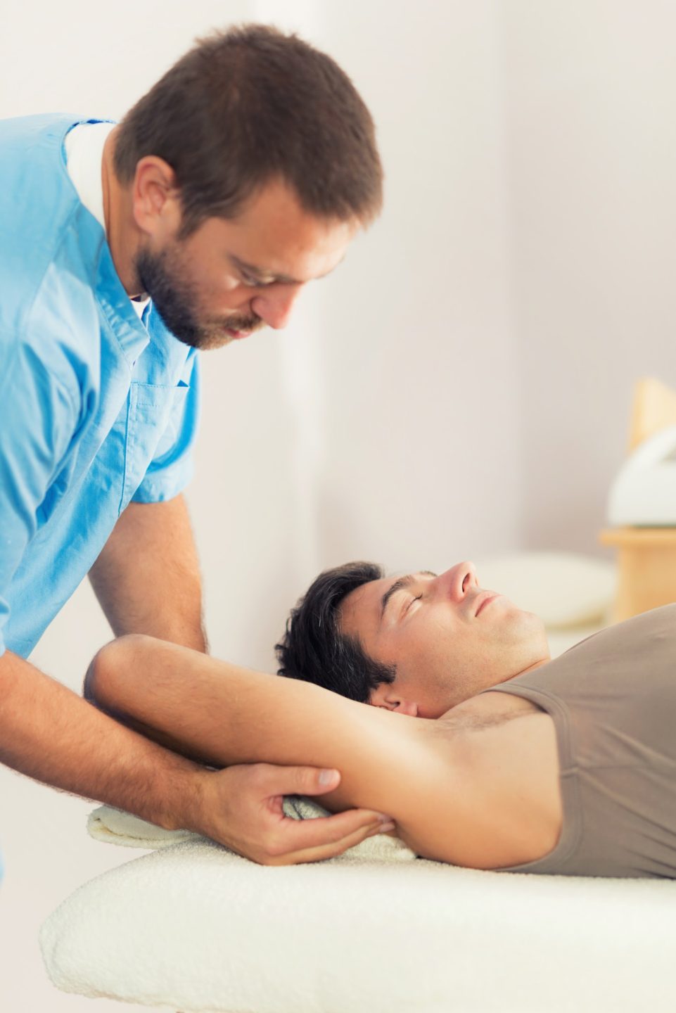 Physiotherapist Working With Patient Arm