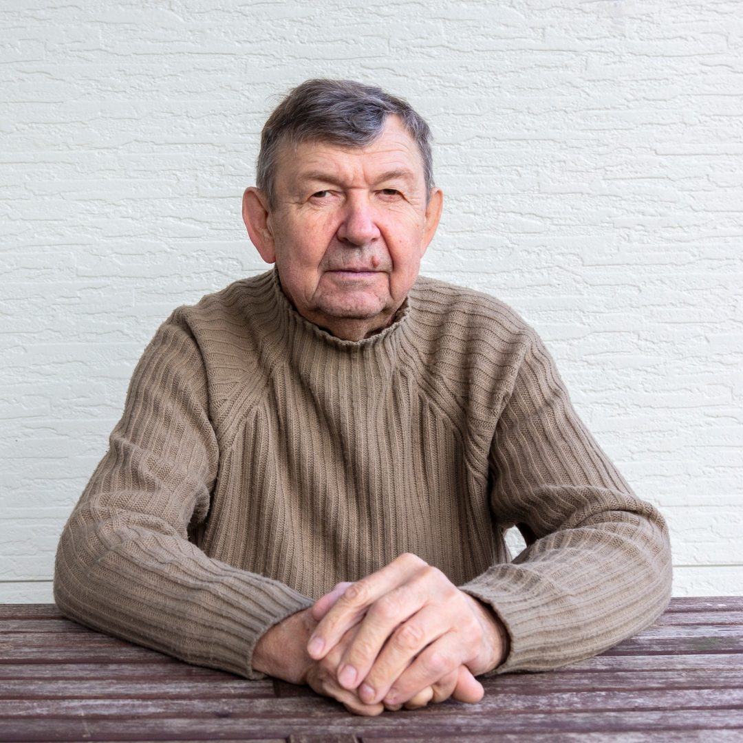 Portrait of elderly man sitting at table