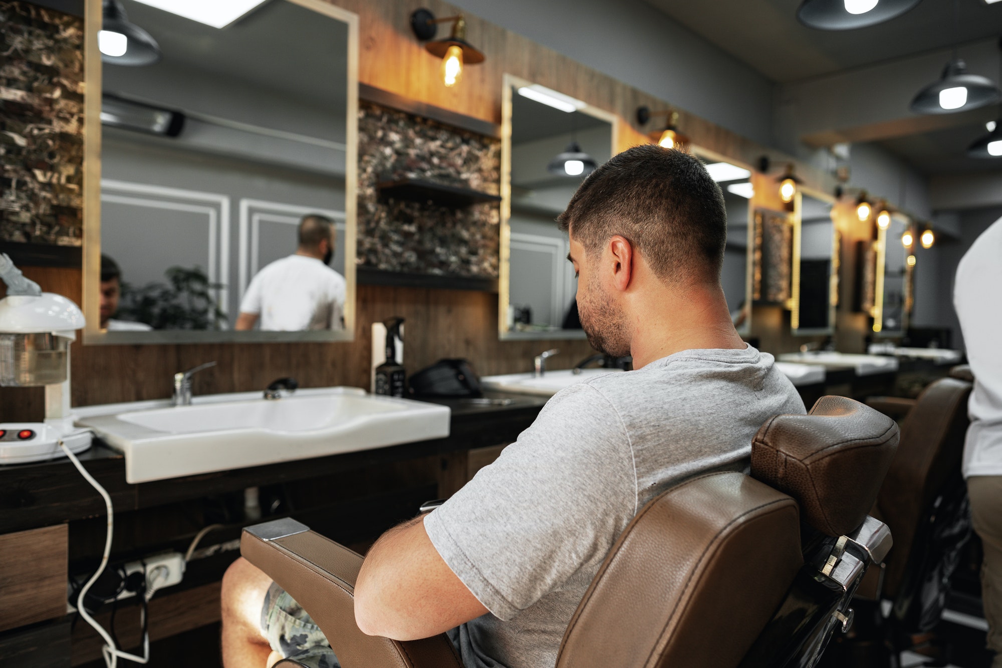 Young man client sitting in a barber shop