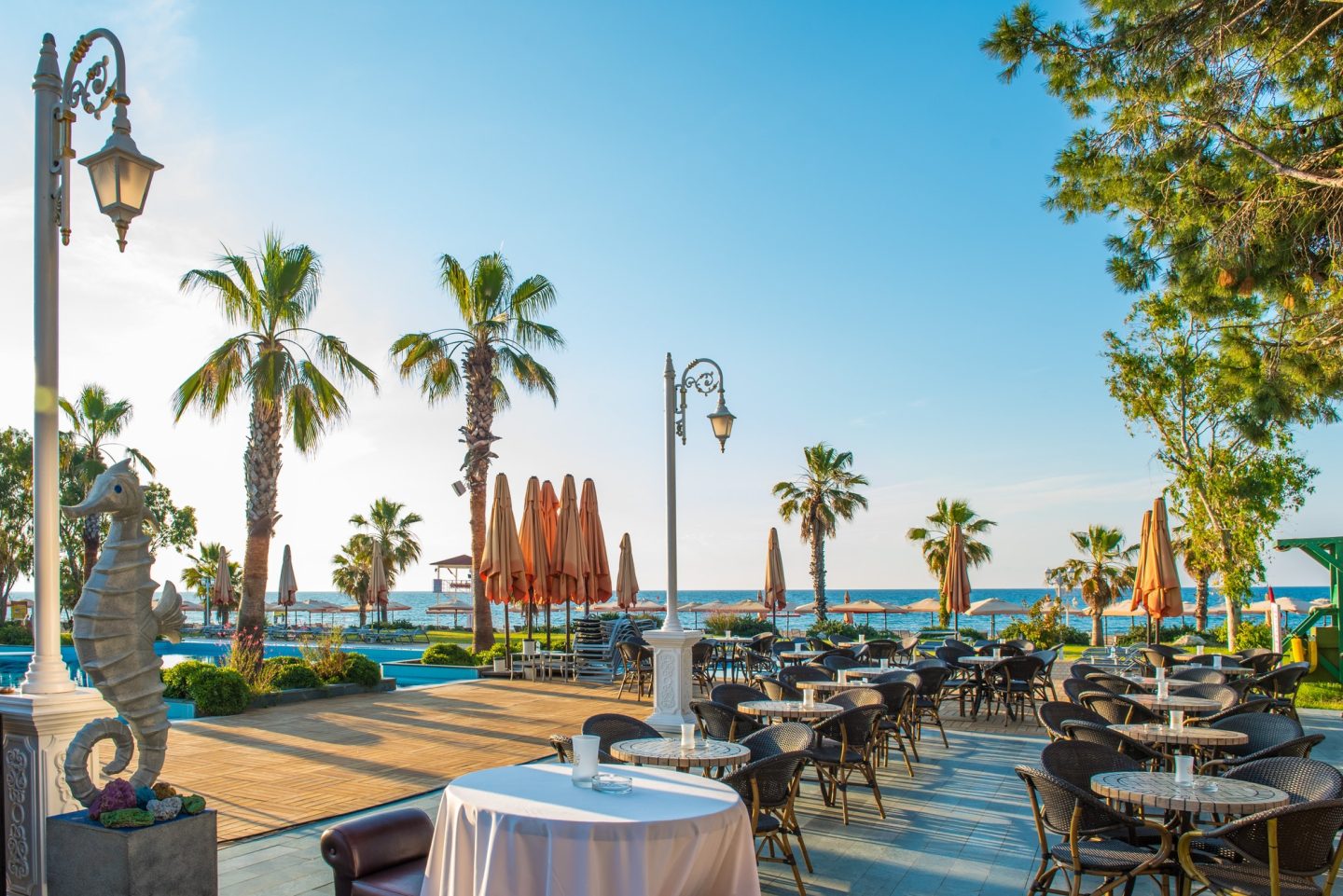 Beautiful view on outdoors terrace of pavement restaurant near the sea. Luxury summer resort.