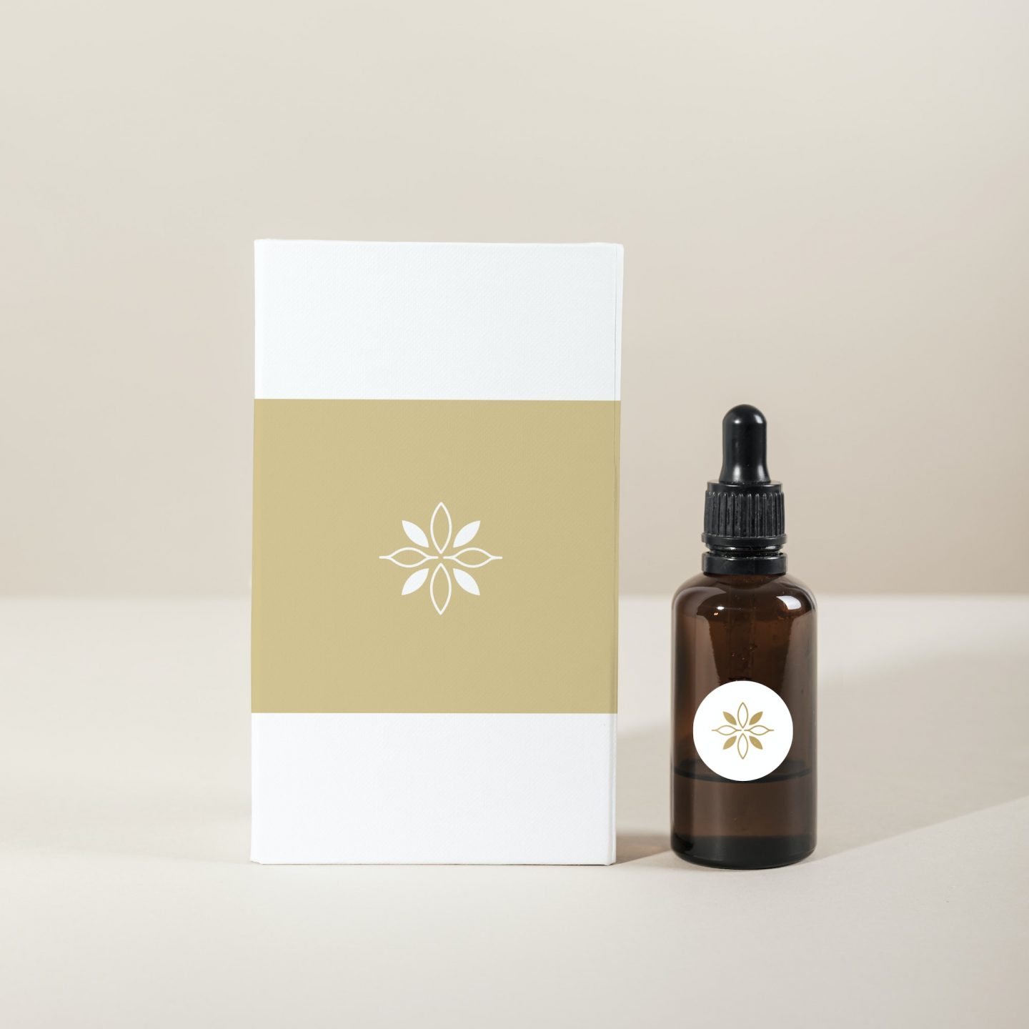 Brown glass dropper bottle with a white box product mockup