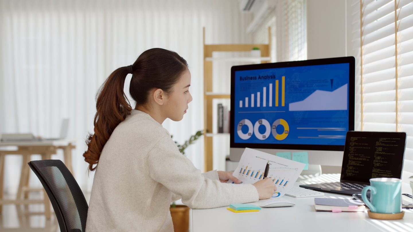 Young attractive asian thai woman employee busy work online multiple screen laptop computer