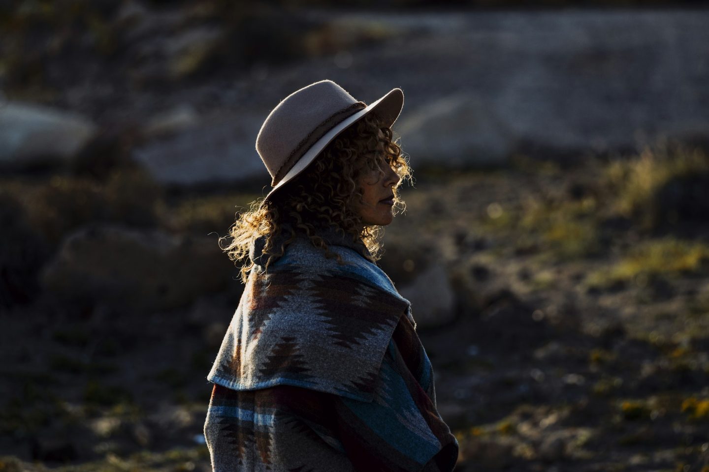 Back view of cute fashion travel woman enjoying outdoor leisure activity in the sunset light