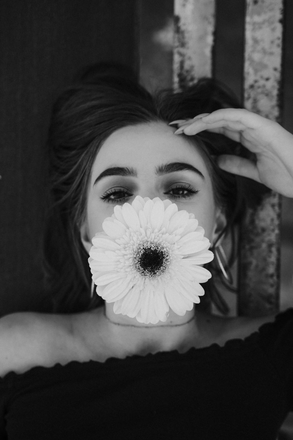 Black and white portrait of a young girl with a flower
