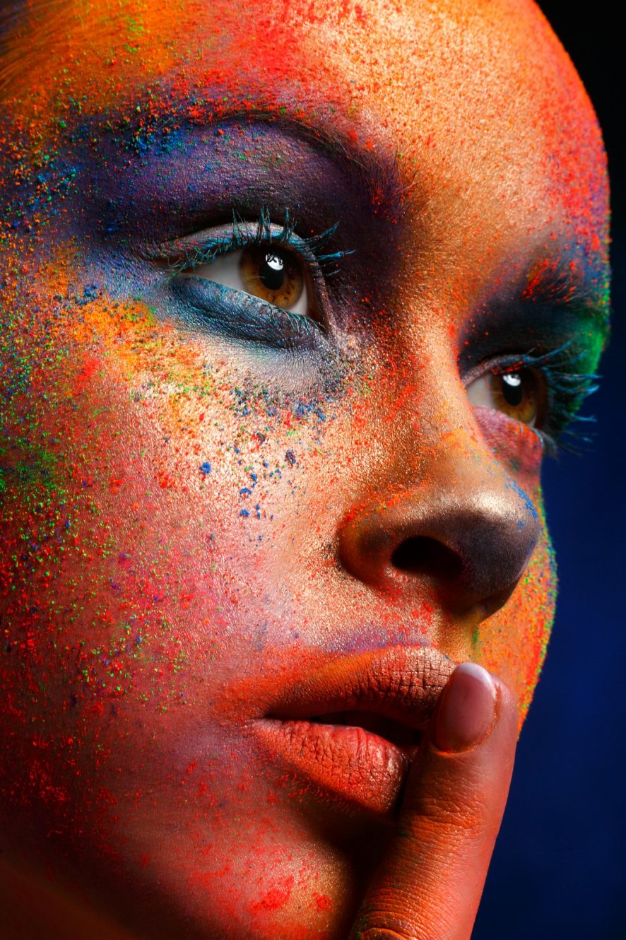 Model with art make-up posing on dark background