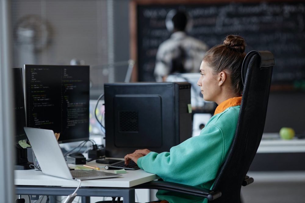 Woman developing software on computer