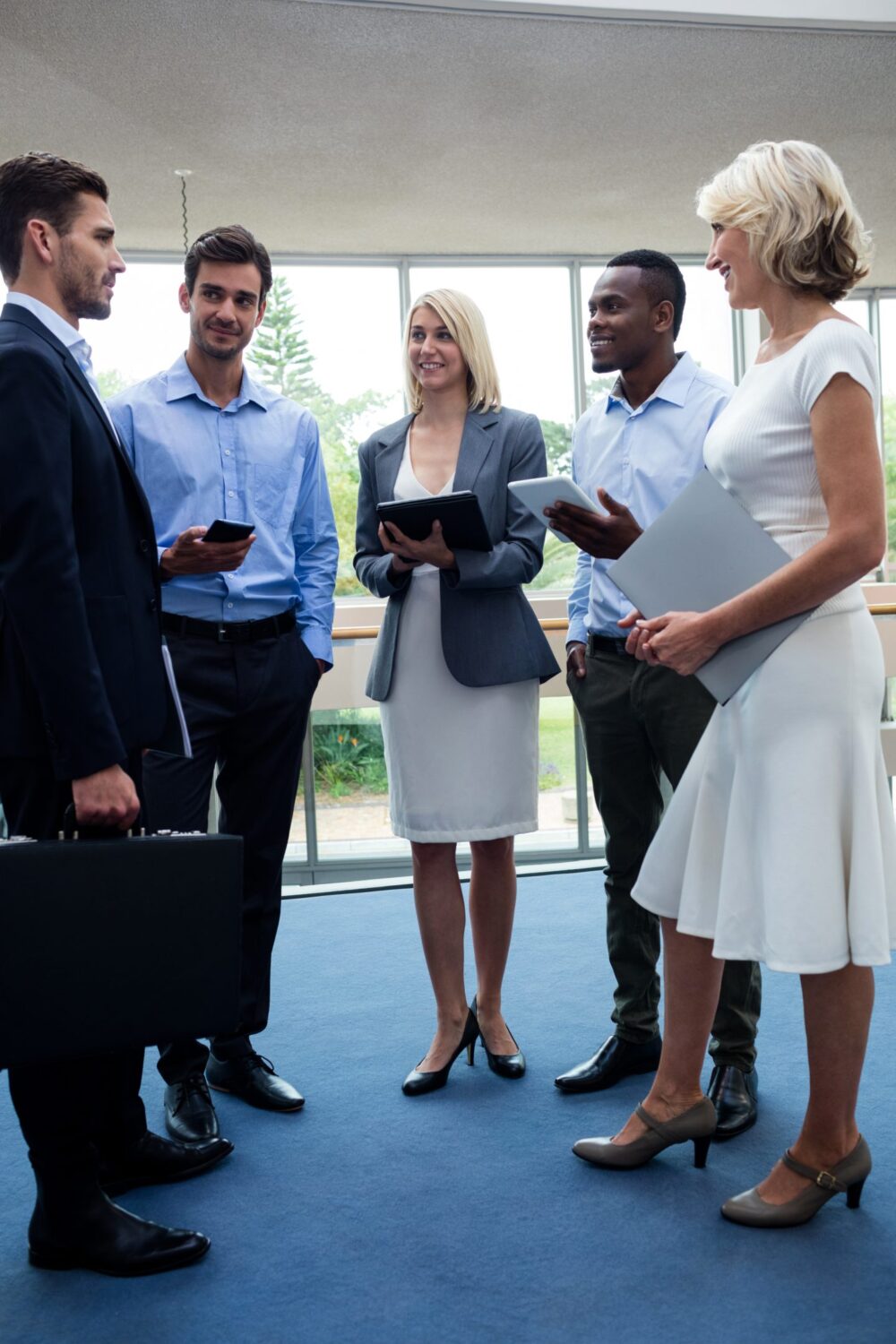 Business executives interacting in a conference center lobby