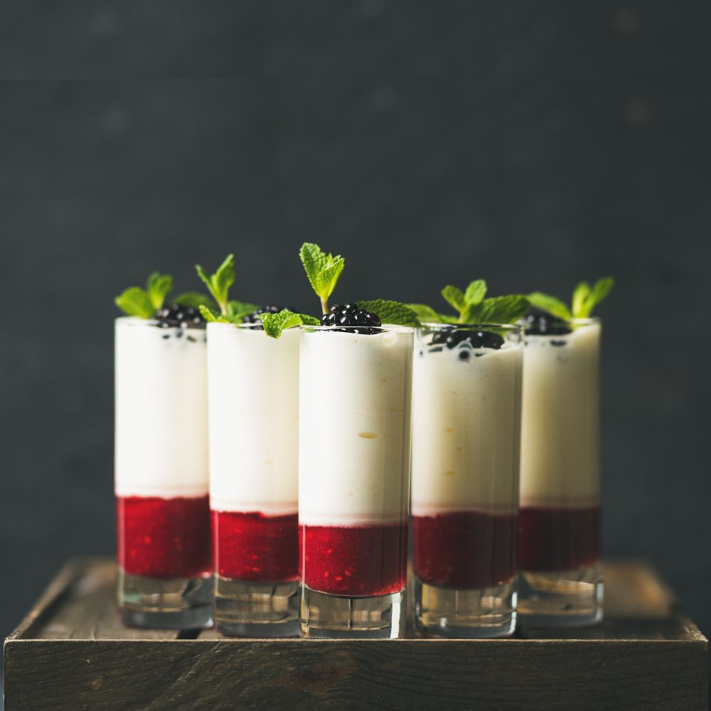 Dessert in glass with blackberries and mint, square crop