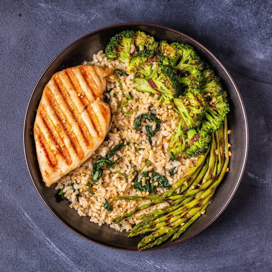 Grilled chicken breast with brown rice, spinach, broccoli, asparagus