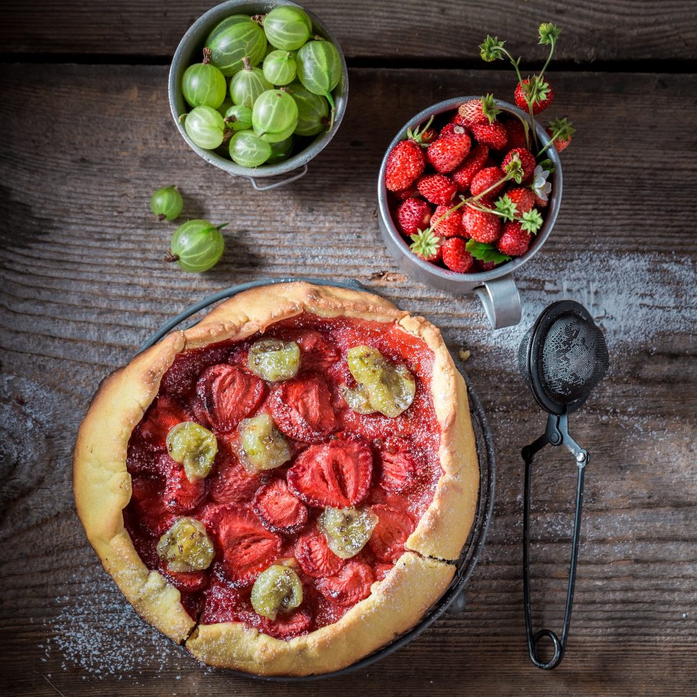 Tasty tart with gooseberries and strawberries Homemade berries tart.