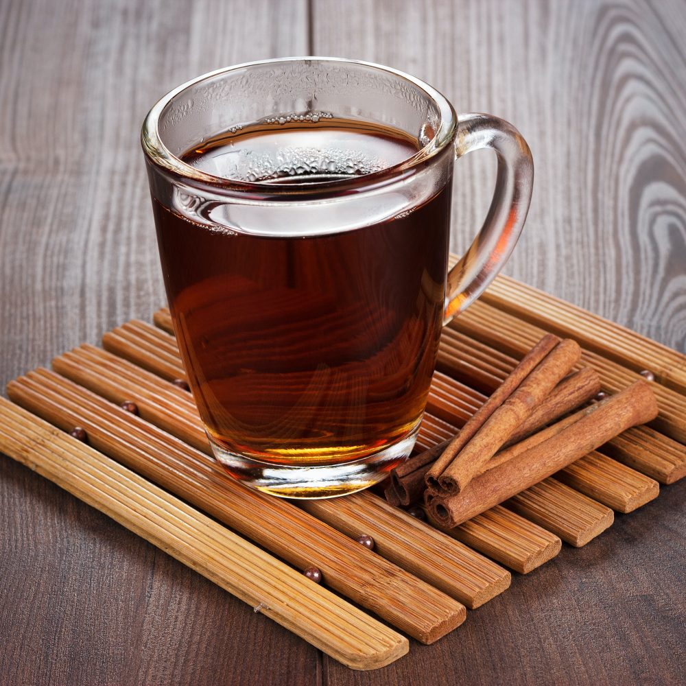 Teacup With Hot Tea And Cinnamon Sticks