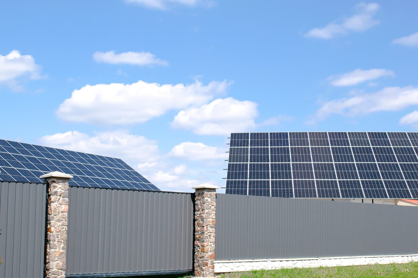 new modern residential house cottage with solar photo voltaic panel system on roof.ecological energy