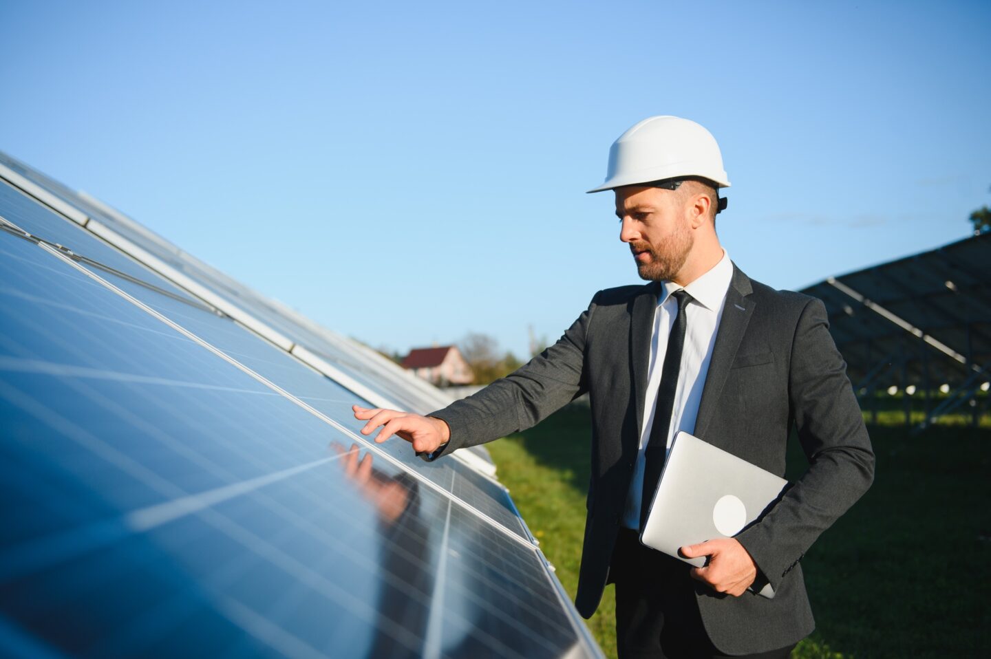 Solar power plant. Man standing near solar panels. Renewable energy