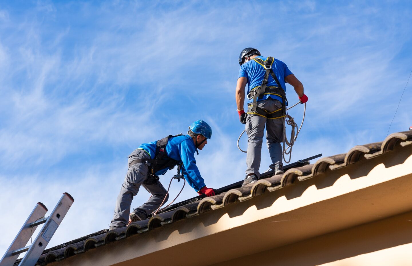Workers installing solar panels on a house. renewable solar energy