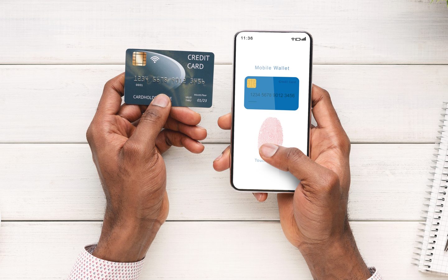 Man Holding Card And Phone With Mobile Wallet App